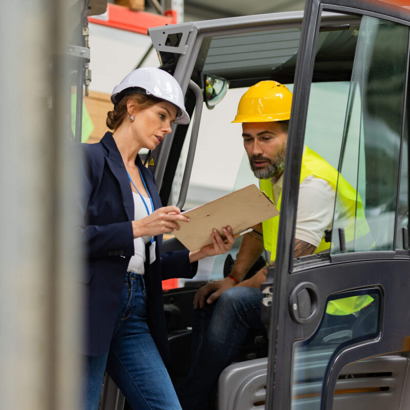 Manager and forklift driver discuss the day's assignment