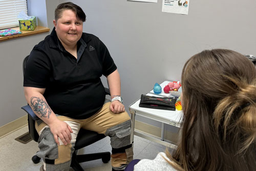 Doctor talking to a patient in hospital room.